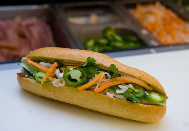 A banh mi sandwich sits prepared for eat vietnamese 
