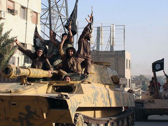 Undated image posted by Raqqa Media Center, a Syrian opposition group, on June 30, 2014, which has been verified and is consistent with other AP reporting, shows fighters from the Islamic State of Iraq and Syria (ISIS) during parade in Raqqa, Syria 