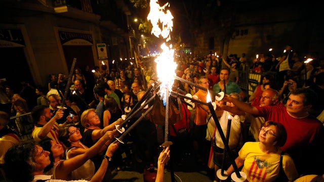 People light torches before a march on the eve of "Diada de Catalunya" (Catalunya's National Day) in central Barcelona 