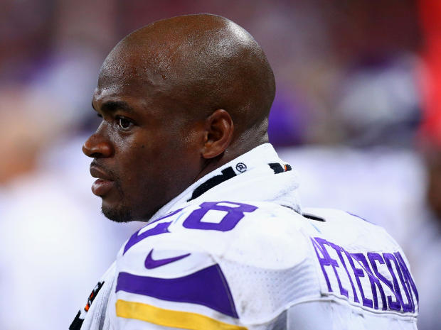 Adrian Peterson looks on from the sideline during a Minnesota Vikings game against the St. Louis Rams on Sept. 7, 2014 