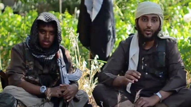 Two members of the Islamic State of Syria and Iraq, identified as British nationals, appear in a propaganda video 