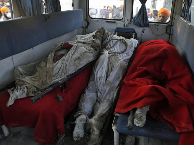 Bodies of flood victims lie in an ambulance after they were pulled from the debris of a house that was damaged by floods in Srinagar 