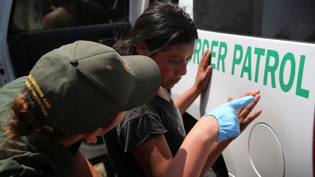 An undocumented immigrant awaits transport to a U.S. Customs and Border Protection processing center after being detained July 22, 2014, near Falfurrias, Texas. 
