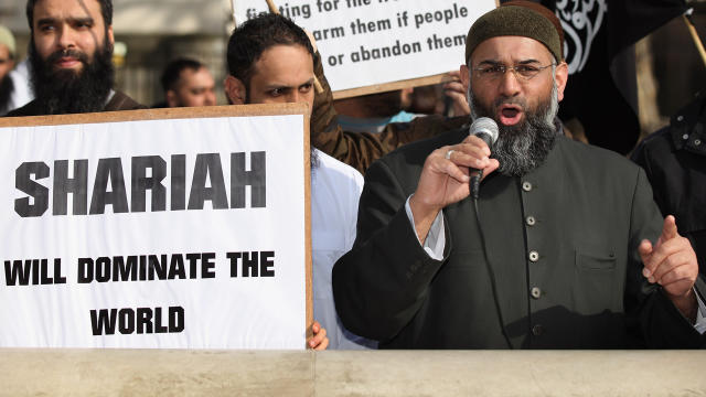 Anjem Choudary (R) speaks at a protest 