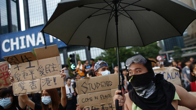 Protesters gather around Golden Bauhinia Square before an official flag raising ceremony to commemorate the Chinese National Day in Hong Kong 