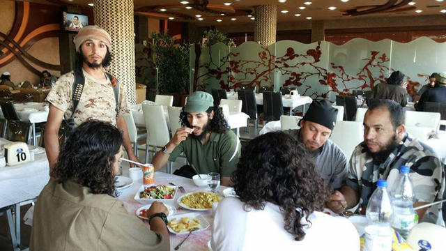 ​A picture released by the Syrian Observatory for Human Rights shows purported ISIS militants enjoying a meal at a restaurant in Raqqa 