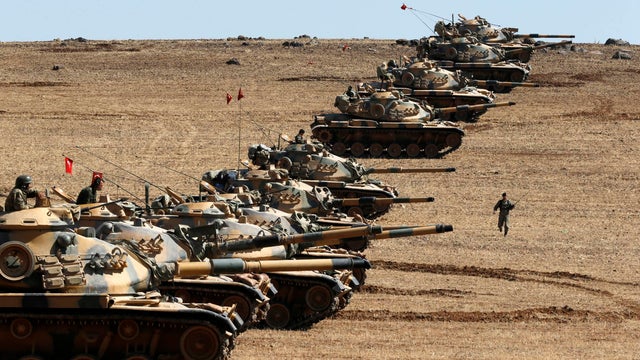 Turkish army tanks take up position on the Turkish-Syrian border near the southeastern town of Suruc, across the border from Kobani 
