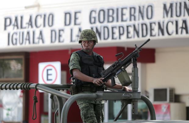 A Mexican soldier patrols in downtown Iguala, Guerrero state, Mexico 