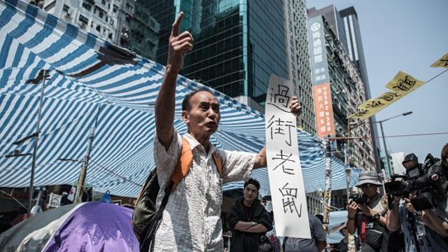 A man protests against the barricades set up by pro-democracy demonstrators in Hong Kong 