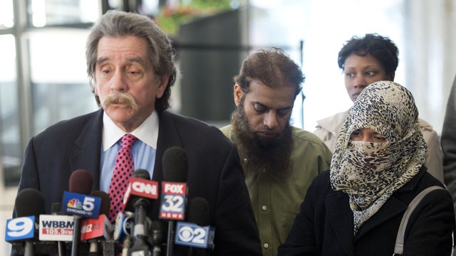 Zarine Kahn, right, and Shafi Ullah Khan, center, the parents of Mohammed Hamzah Khan, 19, listen as their son's attorney, Thomas Anthony Durkin, speaks to reporters after a bond hearing for their son Oct. 9, 2014, in Chicago. 