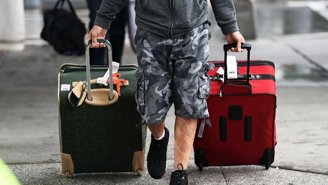 Arriving passengers make their way from Terminal 4 at Kennedy International Airport in New York Oct. 11, 2014, as the airport began new Ebola screening measures for travelers arriving from West Africa. 