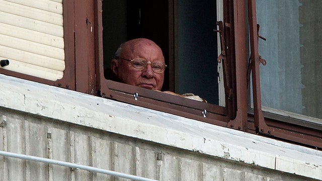 Former Nazi death camp guard Jakob Denzinger looks out his apartment window in Osijek, eastern Croatia.jpg 