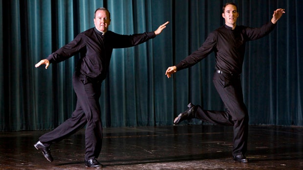 The Rev. David Rider, left, and the Rev. John Gibson dance before an interview with The Associated Press at the Pontifical North American College in Rome Oct. 13, 2014. 