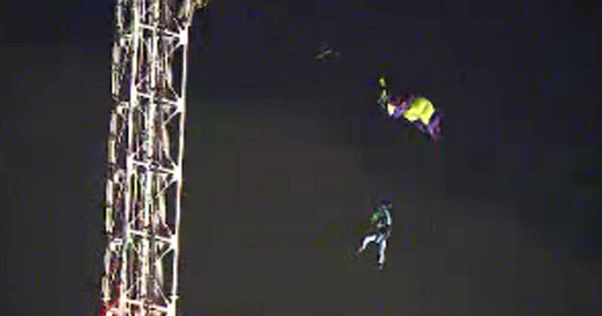 Parachutist dangles for 2 hours way up in the air - CBS News