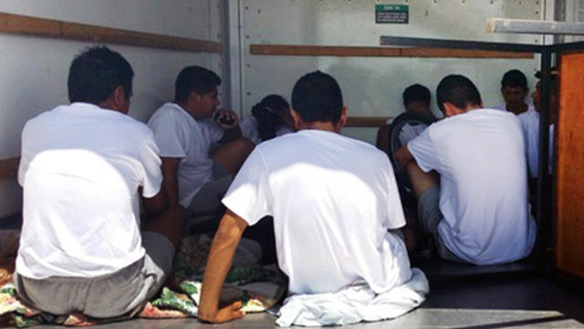 Some of the nine immigrants who entered the United States illegally who were found locked inside the cargo area of a rental truck at a Border Patrol checkpoint outside of Amado, Ariz., are seen Aug. 14, 2014, in this picture released by U.S. Customs and B 