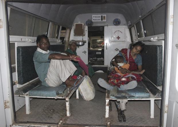 A woman (R), who underwent a botched sterilization surgery at a government mass sterilization "camp", feeds her baby as she sits inside an ambulance while being moved to Chhattisgarh Institute of Medical Sciences (CIMS) hospital from a district hospital in Bilaspur 
