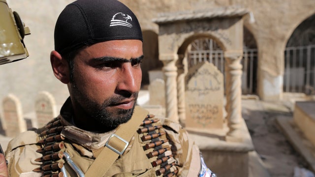 Dwekh Nawsha militia member stands guard 