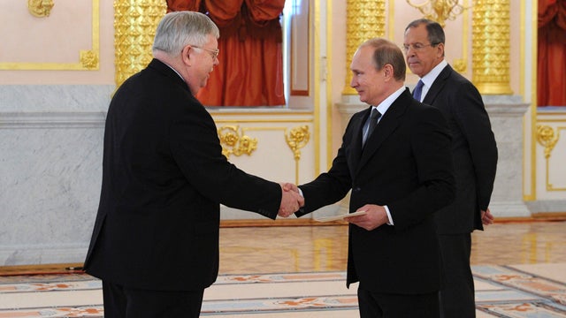 New U.S. ambassador to Russia John Tefft (L) shakes hands and presents his credentials to Russian President Vladimir Putin during a ceremony at the Kremlin in Moscow 