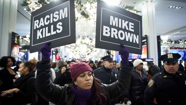 A protester marches though Macy's flagship store in New York City in support of the late Michael Brown Nov. 28, 2014. The unarmed 18-year-old was shot to death in Ferguson, Missouri, by police officer Darren Wilson.