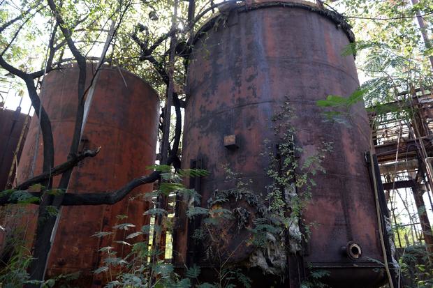 Abandoned equipment and broken storage tanks are seen at the now-defunct Union Carbide pesticide factory in Bhopal Nov. 28, 2014. 