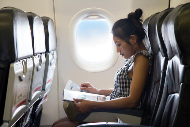airplane seat travel magazine reading 