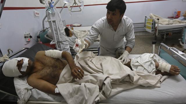 An Afghan man receives treatment at a hospital after a suicide attack inside a school in Kabul 