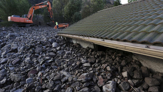Rocks reach the roof of a home after a mudslide overtook several homes during heavy rains in Camarillo, California, Dec. 12, 2014. 