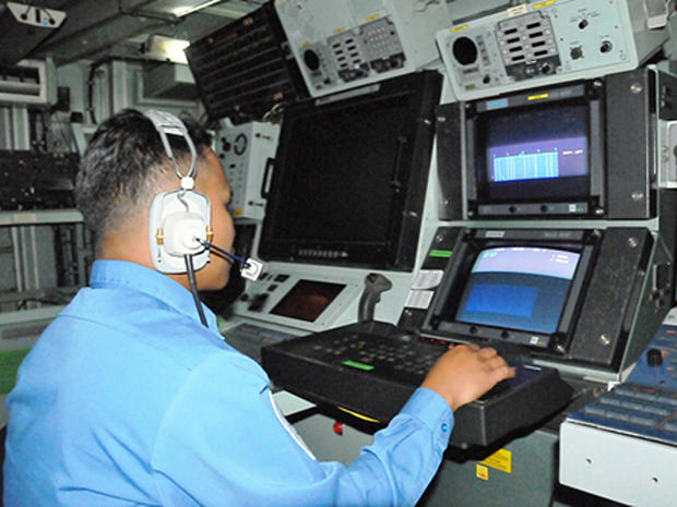 A Royal Malaysian Navy sailor watches sonar imagery on a monitor on board the RMN ship KD Lekiu as the search for AirAsia Flight 8501 continues 