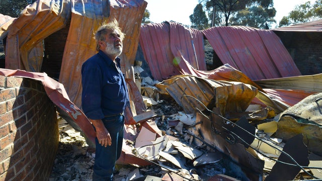 Resident David Miller surveys the remains of his home near Kersbrook that was destroyed by a bushfire in the Adelaide Hill 