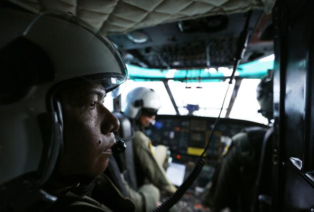 Indonesia Air Force members are seen inside a Super Puma helicopter during search of Java Sea, off Indonesia, on January 7, 2015, for passengers from AirAsia Flight 8501 
