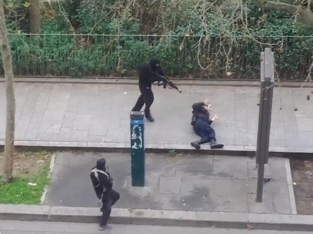 An image from video posted online shows masked gunmen just before one of them appears to shoot a Paris police officer at close range, following an attack on the office of weekly newspaper Charlie Hebdo 