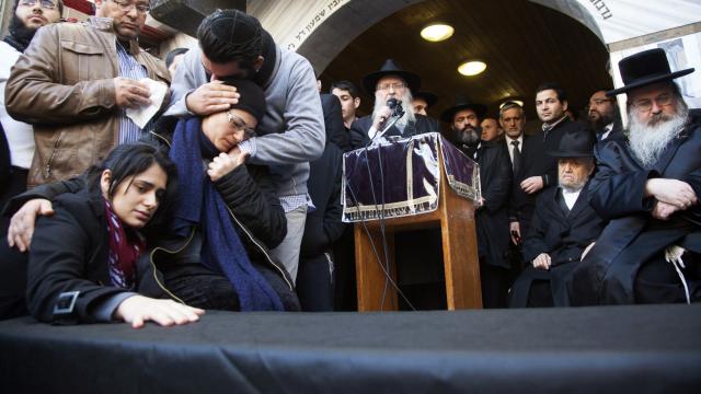 The mother (2nd L) and sister (L) of Yoav Hattab, killed in an attack on a Paris grocery on Friday, mourn beside a symbolic coffin during a procession in Bnei Brak near Tel Aviv 