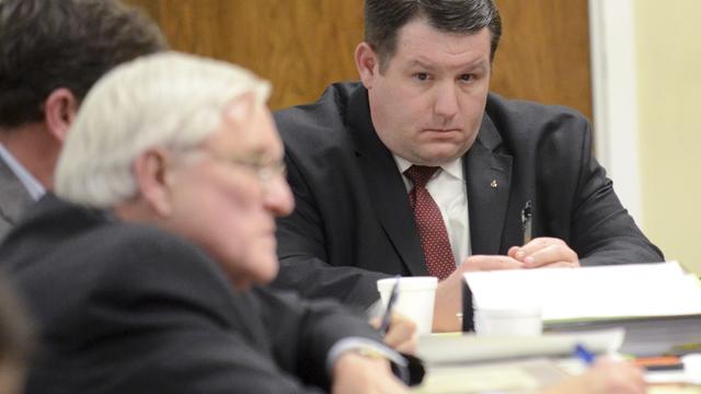 Former Eutawville Police Chief Richard Combs sits with lawyers during his trial for the May 2011 murder of Bernard Bailey in Orangeburg, South Carolina, on January 8, 2015 