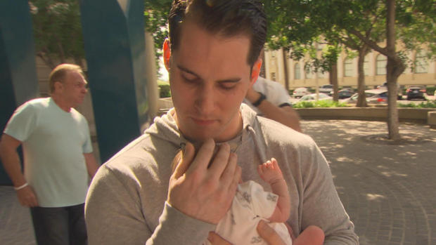 Christian Smith holds his newborn daughter for the first time 