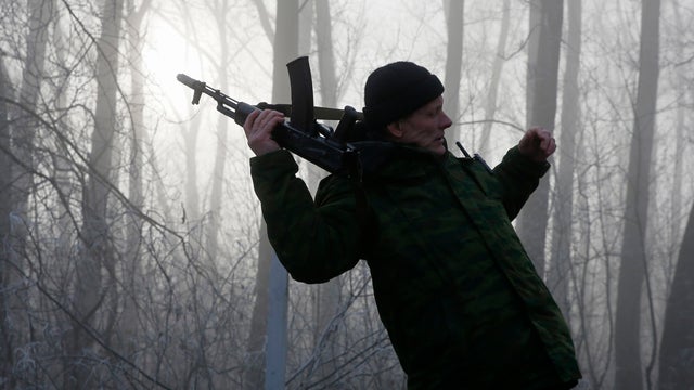 A pro-Russian rebel re-adjusts his AK machine gun outside of the town of Panteleimonovka, northeast of Donetsk, in this Dec.14, 2014. 