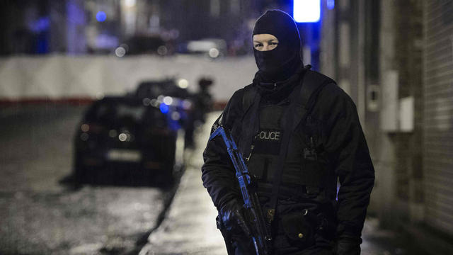 A Belgian special forces police officer blocks a street in central Verviers, a town between Liege and the German border, in the east of Belgium 