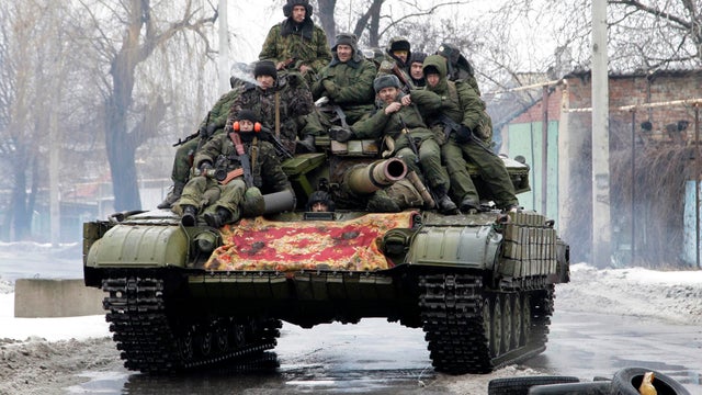 Members of the armed forces of the separatist self-proclaimed Donetsk People's Republic drive a tank on the outskirts of Donetsk 