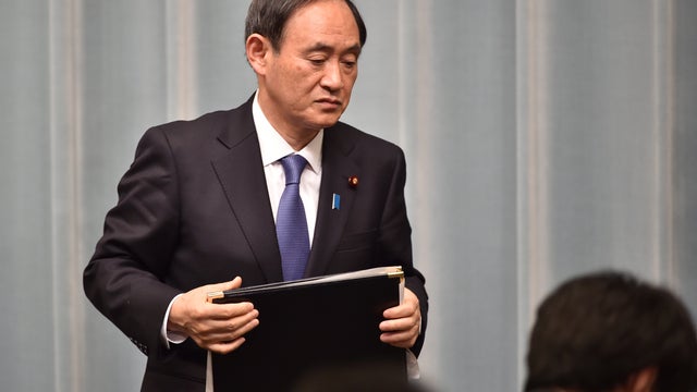 Japan's Chief Cabinet Secretary Yoshihide Suga leaves after a press conference at the prime minister's official residence in Tokyo on Jan. 25, 2015. 