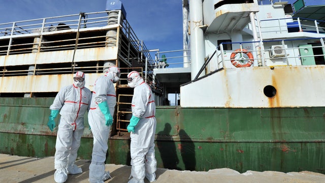 Icelandic coastguard volunteers check the ship Ezadeen at Corigliano harbor, Italy 