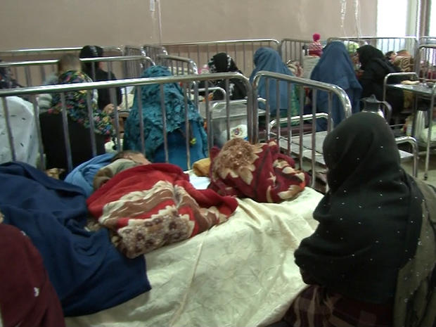 A ward room at Kabul's Indira Gandhi children's hospital is crowded with patients and women 