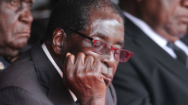 Zimbabwe's President Robert Mugabe rests on his forearm during the funeral of president Michael Sata at Heroes Stadium on Nov. 11, 2014 in Lusaka.  