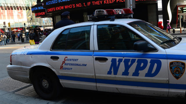 A New York Police Department car takes a position as a news ticker announces April 25, 2013, that suspects in the Boston Marathon bombing were plotting attacks on New York City's Times Square in New York. 