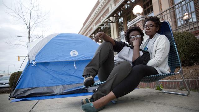 Shanté Wolfe, left and Tori Sisson, right, sit near the Montgomery County Courthouse, Feb. 8, 2015, in Montgomery, Ala. 