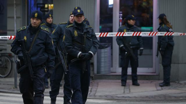 Police officers control the street in front of an internet cafe in Norrebro district in Copenhagen 