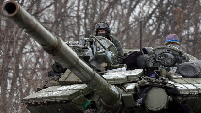 Ukrainian servicemen ride on a tank near Debaltseve 