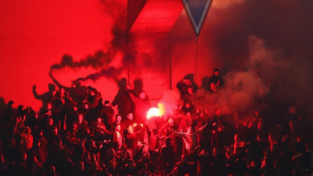 PARIS, FRANCE - FEB. 17: 2015.  Soccer fans light flares during the UEFA Champions League Round of 16 match between Paris Saint-Germain and Chelsea in Paris, France.  