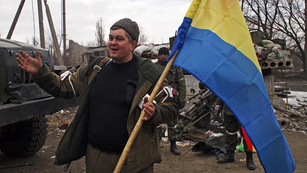 A pro-Russia rebel holds a flag of the rebel-held city of Luhansk in Debaltseve, eastern Ukraine, Feb. 19, 2015. 