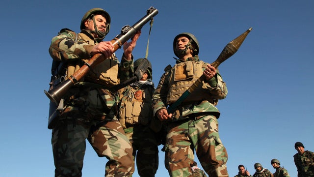 Kurdish Peshmerga fighters inspect an rocket-propelled grenade (RPG) launcher as they take control of the area, on the outskirts of Mosul Feb. 6, 2015. 