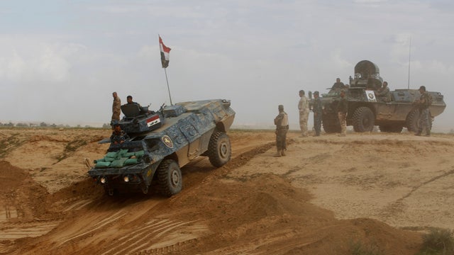 Iraqi security forces and Shiite fighters gather during a deployment in the town of Hamrin, in Salahuddin province 