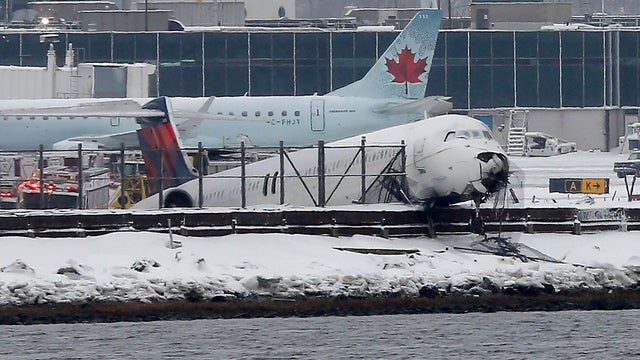 Plane skids off runway at LaGuardia